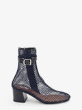 Fishnet 55 mesh and patent leather boots
